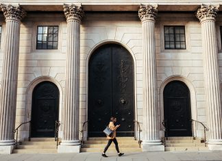 Capital One UK’s Head of Research and Design Strategy speaking at an online event Woman walking in front of a building