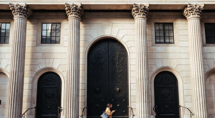 Capital One UK’s Head of Research and Design Strategy speaking at an online event Woman walking in front of a building