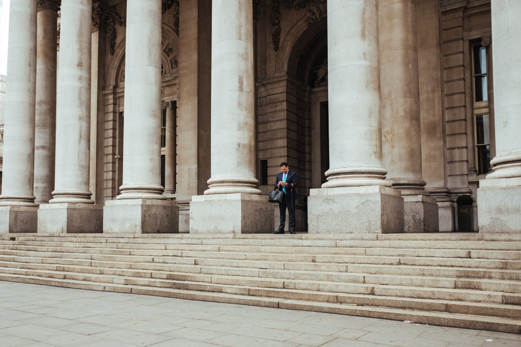 Person standing in front of a pillar